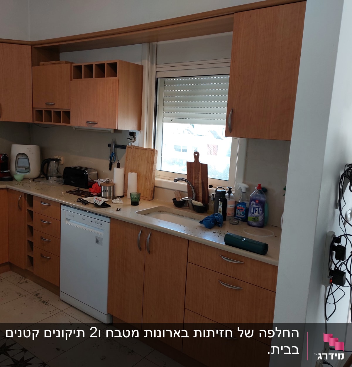 מטבח עם ארונות עץ, כיור, חומרי ניקוי וכלים על השיש